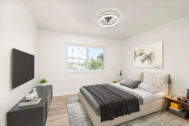 a bedroom with a bed and a flat screen tv