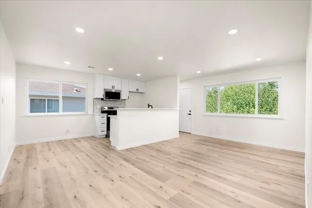 a view of kitchen with wooden floor and window