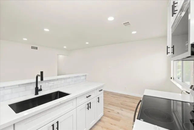 a kitchen with a sink and a refrigerator