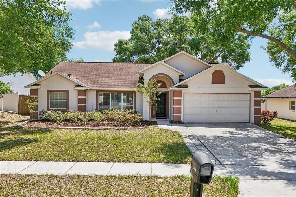 2596 Alclobe Circle Ocoee, FL 34761 - Photo 5 of 70 a front view of a house with a yard and garage