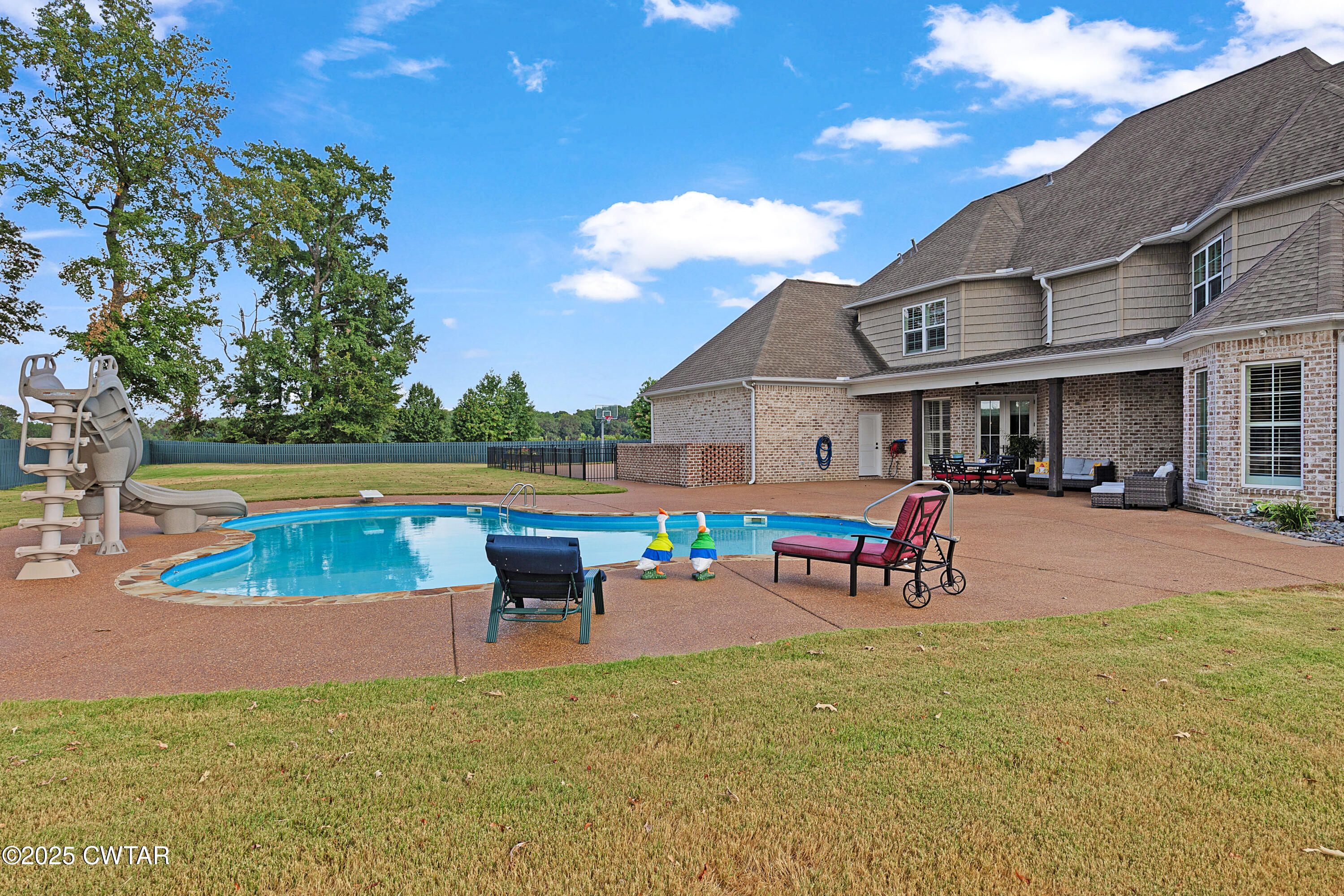 61 Rochester Cove Jackson, TN 38305 - Photo 12 of 55 a view of a house with a swimming pool and sitting area
