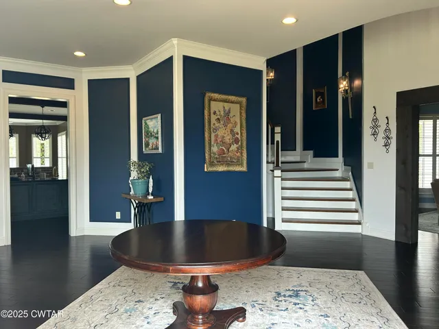 a view of a dining room and livingroom with furniture wooden floor and a rug