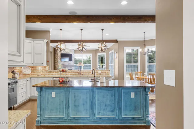 a kitchen with granite countertop lots of counter top space and cabinets