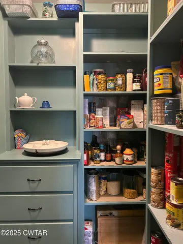 a bedroom with bed and flat screen tv