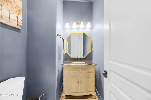 a bathroom with a sink a large mirror and a bathtub