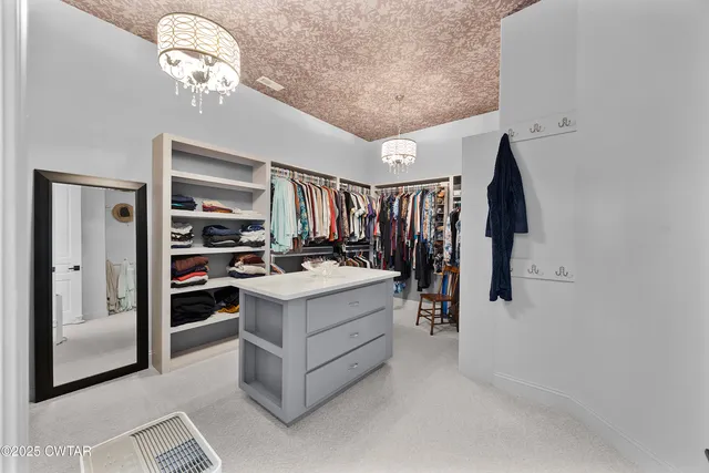 a spacious bathroom with a granite countertop sink a mirror and shower