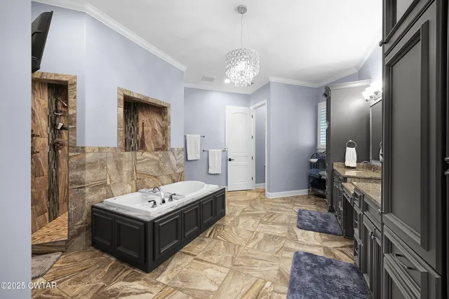 a bathroom with a granite countertop sink a mirror and shower