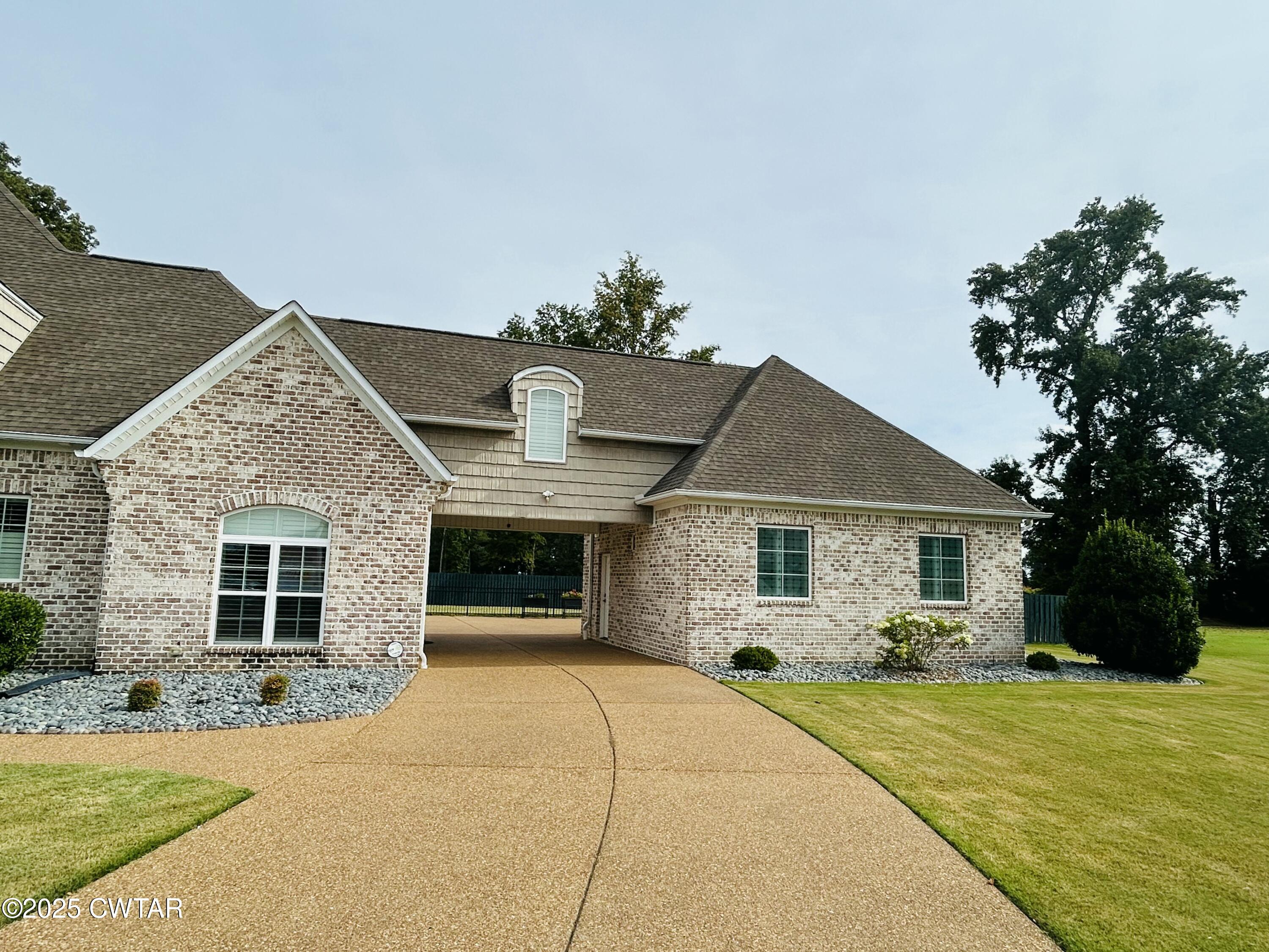 61 Rochester Cove Jackson, TN 38305 - Photo 5 of 55 a front view of a house with a yard and garage