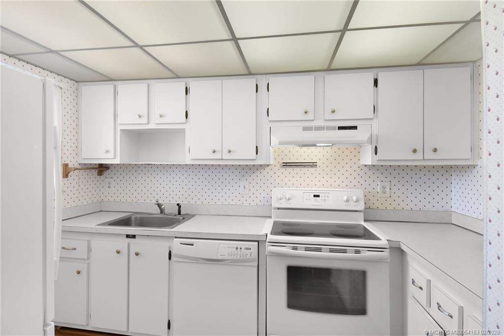 5413 Southeast Miles Grant Road, Unit G206 Stuart, FL 34997 - Photo 9 of 79 a kitchen with cabinets appliances and a sink