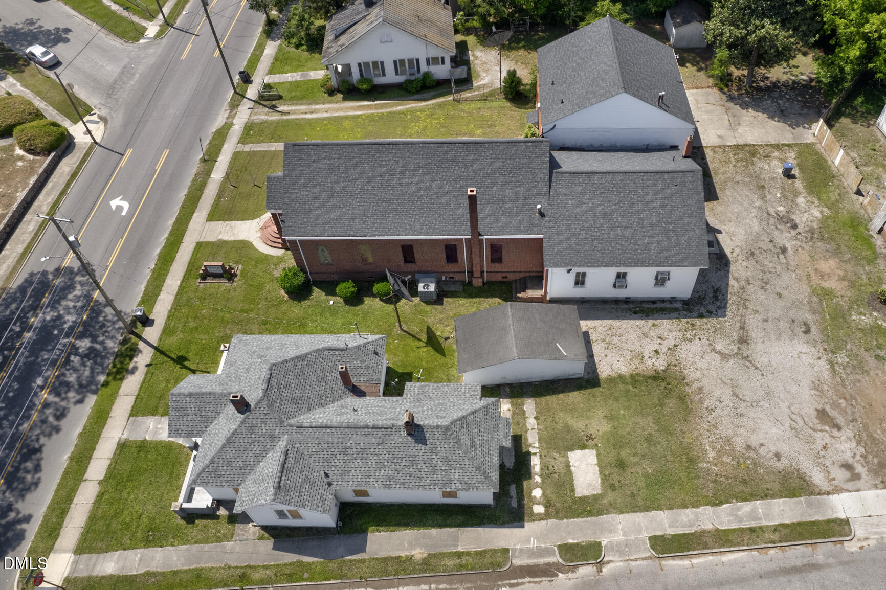 408 Cokey Road Rocky Mount, NC 27801 - Photo 44 of 46 an aerial view of a house with garden space and a car park in front of it