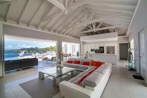 a living room with furniture pool table and a large window
