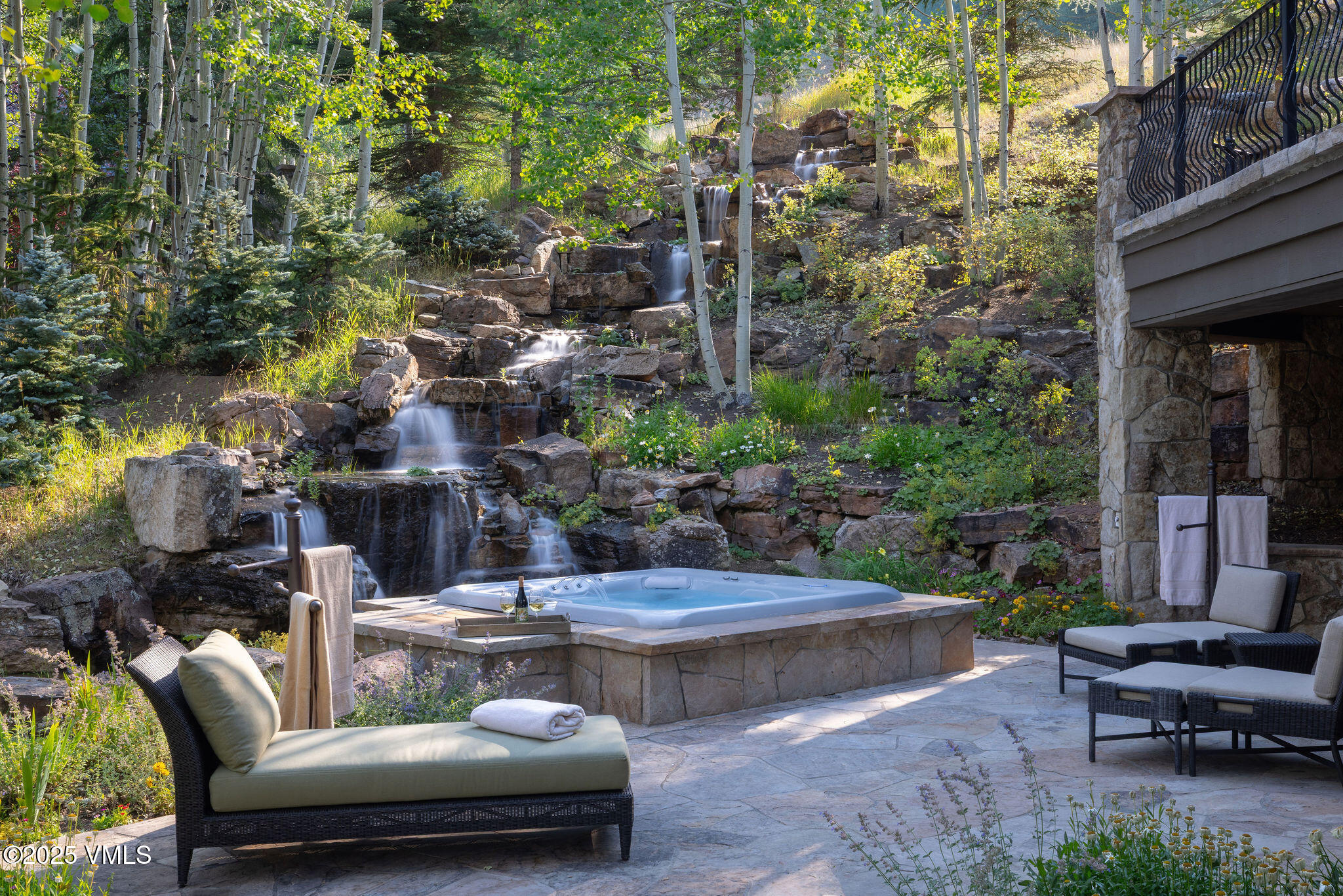 463 Borders Road Beaver Creek, CO 81620 - Photo 11 of 43 a view of a patio with couches table and chairs with potted plants and large trees