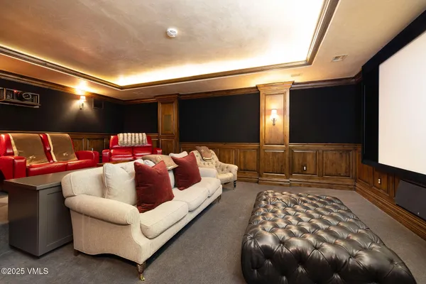 a living room with furniture and large windows