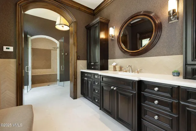 a spacious bathroom with a tub sink shower and mirror