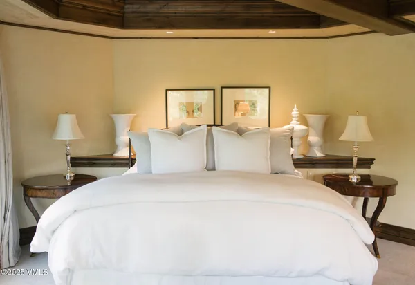 a spacious bedroom with a bed and a fireplace