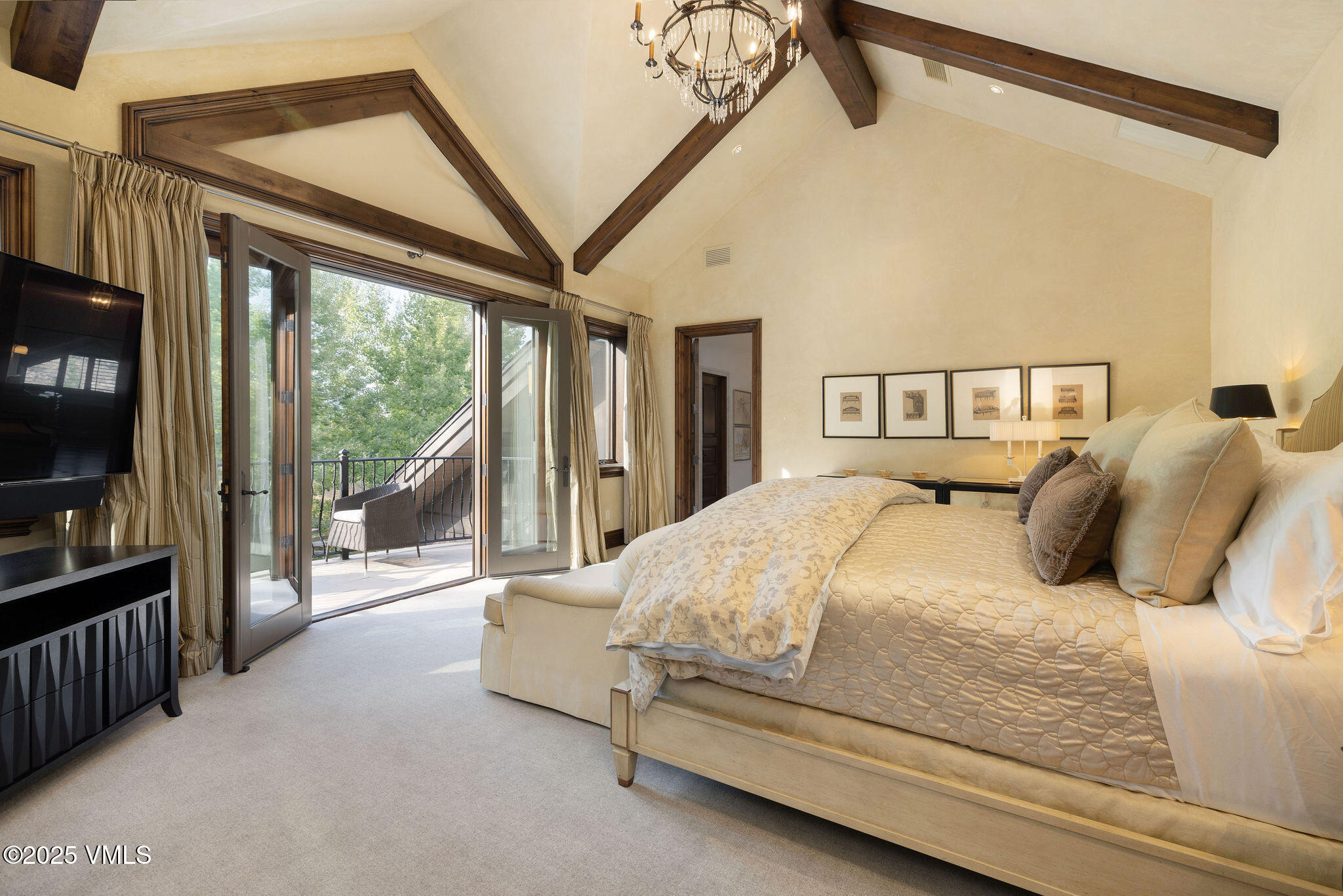 463 Borders Road Beaver Creek, CO 81620 - Photo 26 of 43 a spacious bedroom with a bed and a large window with the outer view