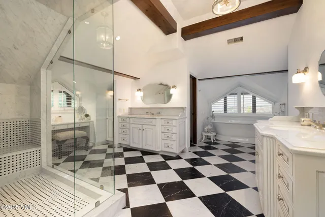 a bathroom with a sink a shower and a mirror