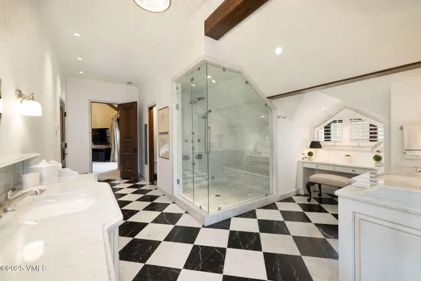 a spacious bathroom with a double vanity sink and a mirror