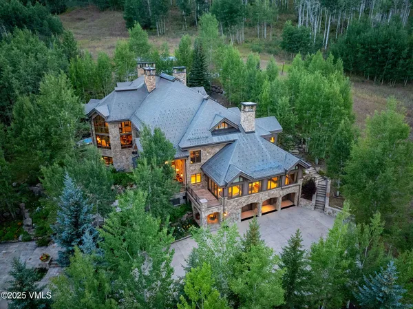an aerial view of a house with yard swimming pool and outdoor seating