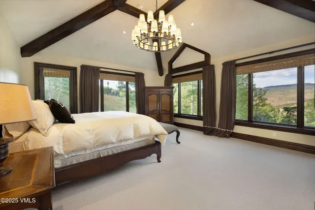 a spacious bedroom with two beds and a large window