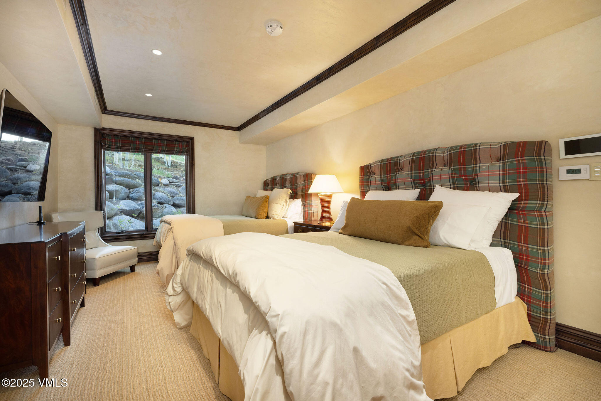 463 Borders Road Beaver Creek, CO 81620 - Photo 35 of 43 a spacious bedroom with a large bed and a large window