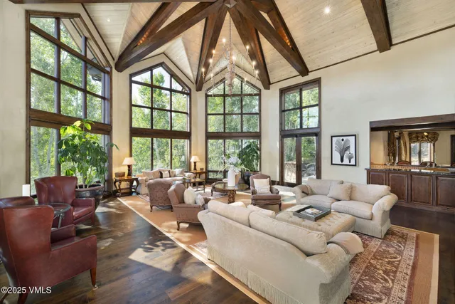a living room with furniture and floor to ceiling windows