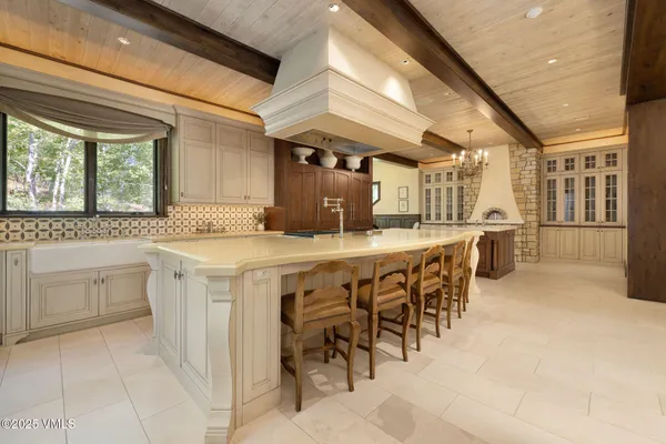 a kitchen with a sink and chairs