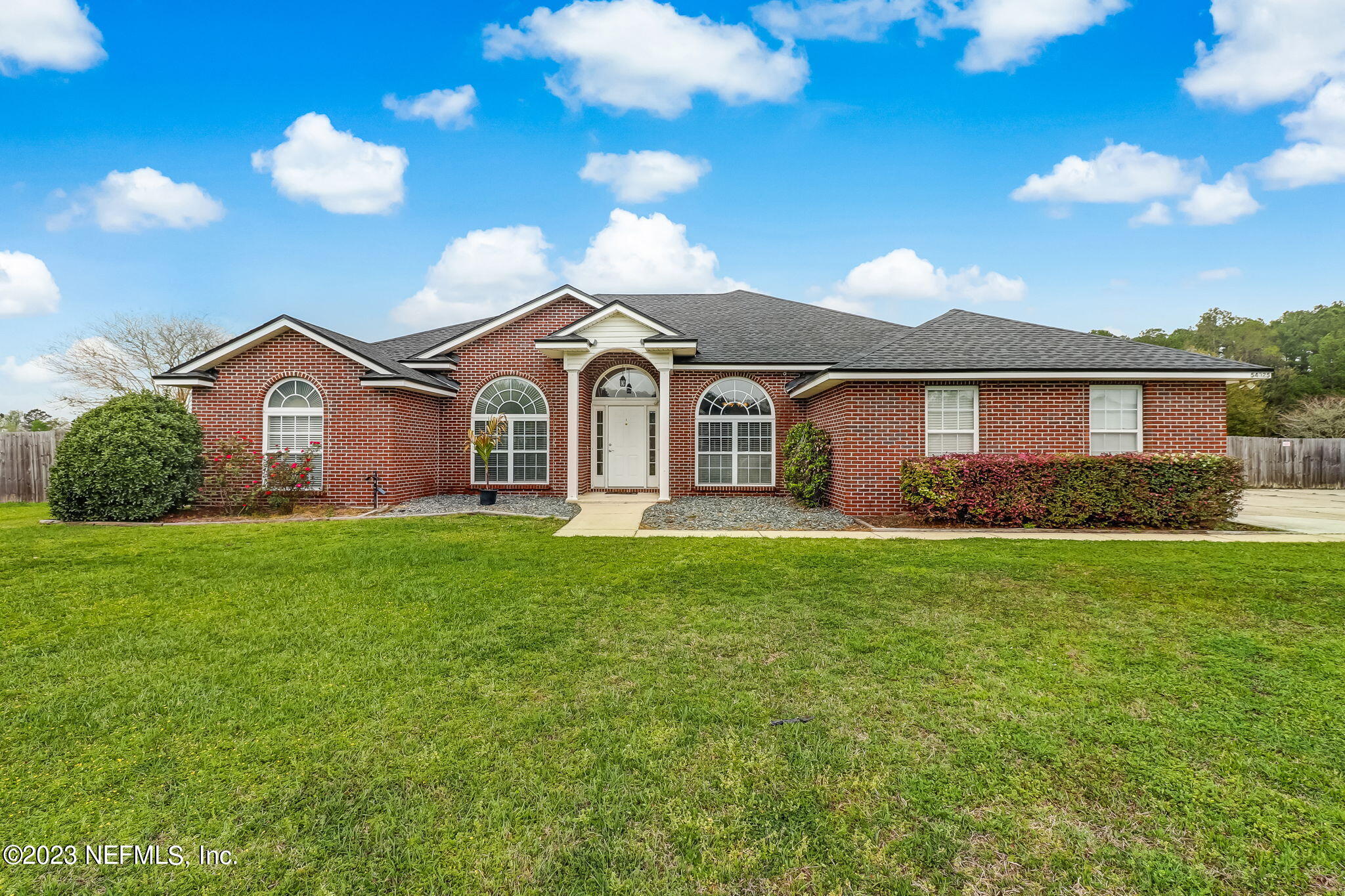 54025 Paddock Court Callahan, FL 32011 - Photo 1 of 47 a front view of a house with garden