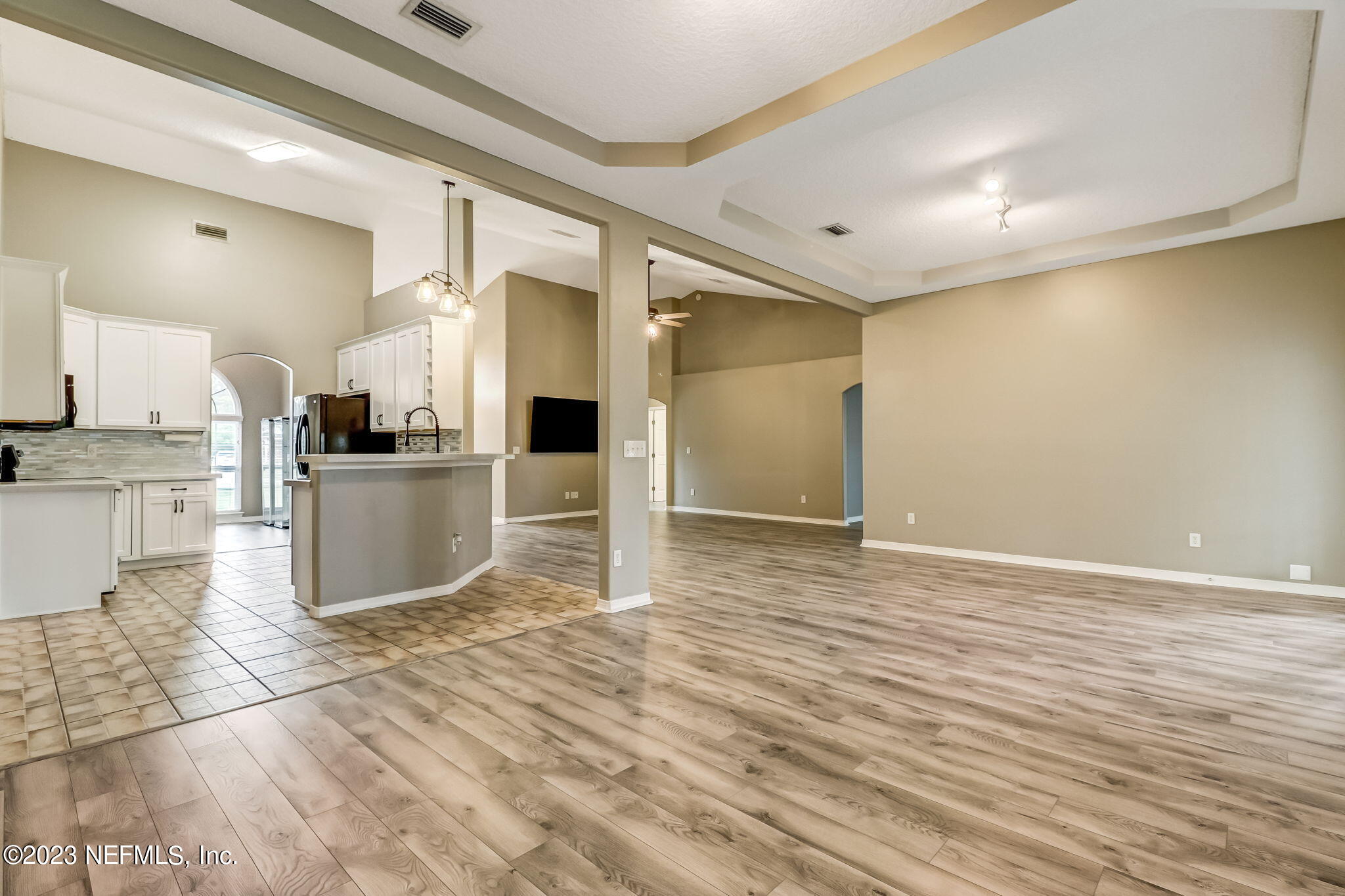 54025 Paddock Court Callahan, FL 32011 - Photo 12 of 47 a kitchen with granite countertop a refrigerator and a stove top oven