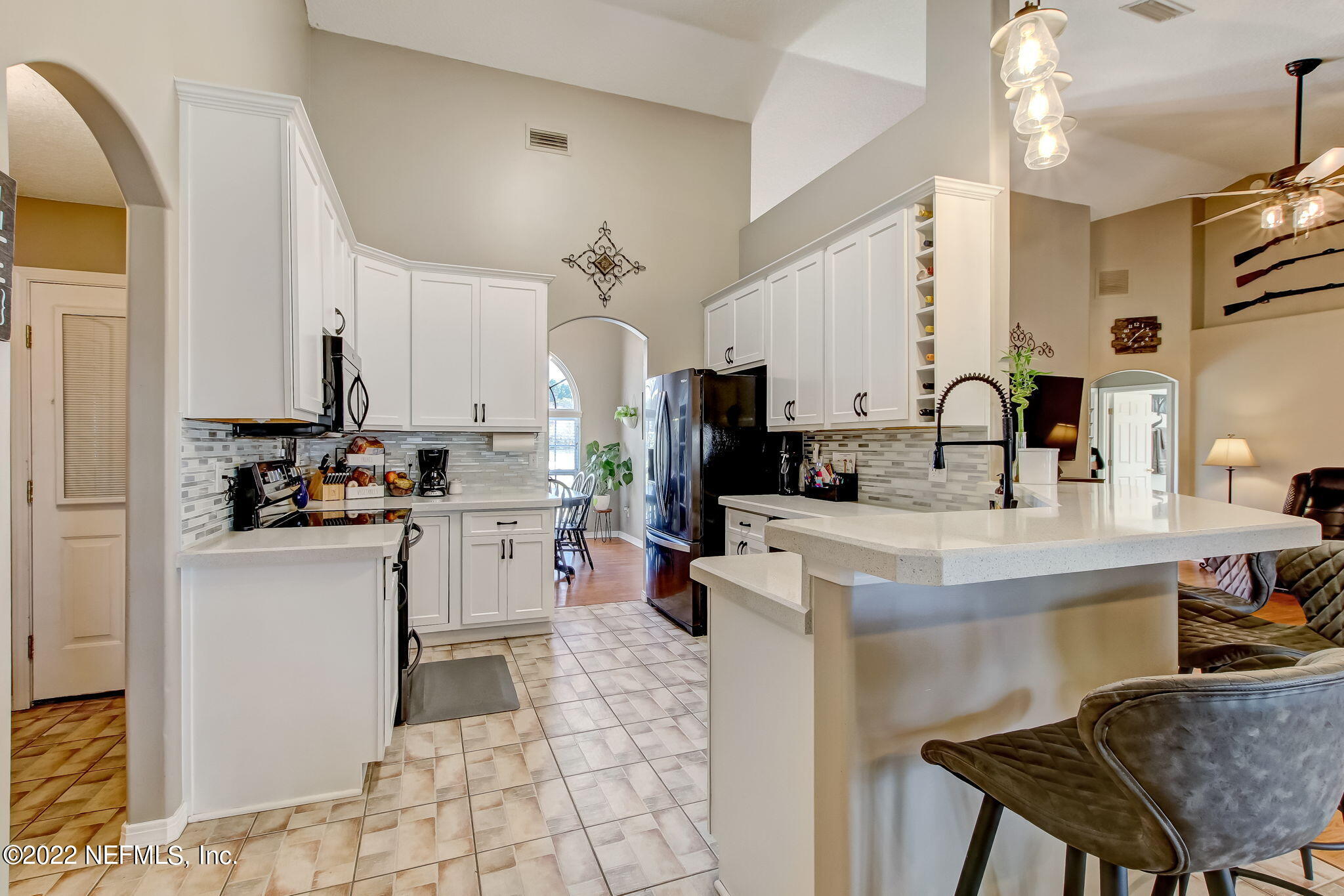 54025 Paddock Court Callahan, FL 32011 - Photo 14 of 47 a kitchen with cabinets and chairs