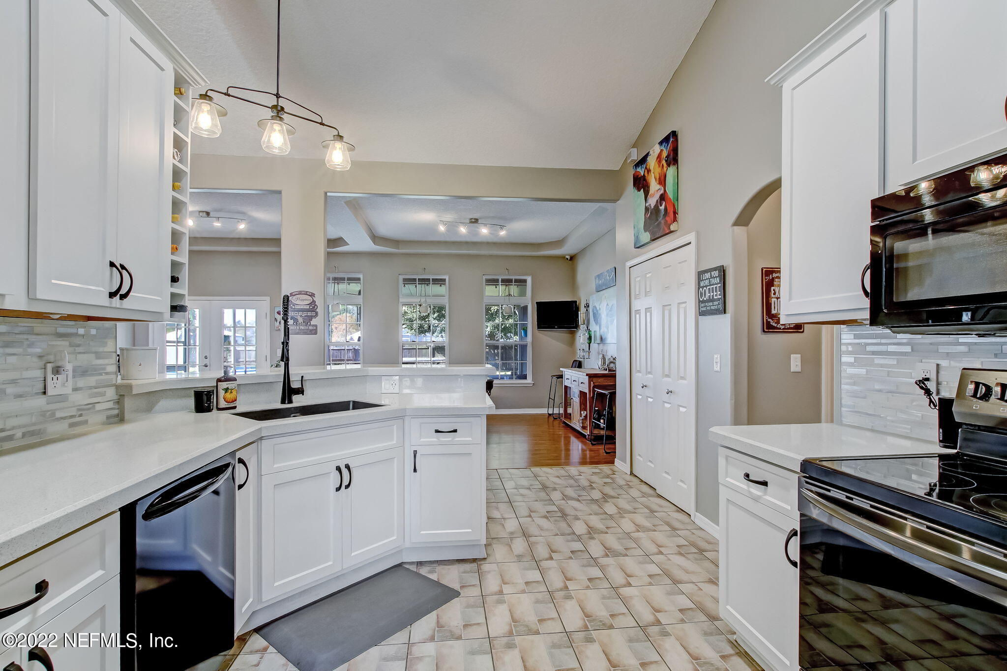 54025 Paddock Court Callahan, FL 32011 - Photo 17 of 47 a kitchen with stainless steel appliances a sink stove and cabinets