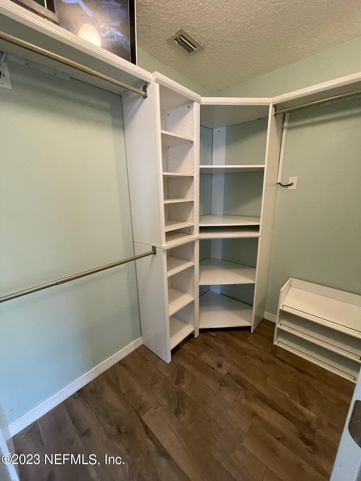54025 Paddock Court Callahan, FL 32011 - Photo 20 of 47 a view of walk in closet with empty racks