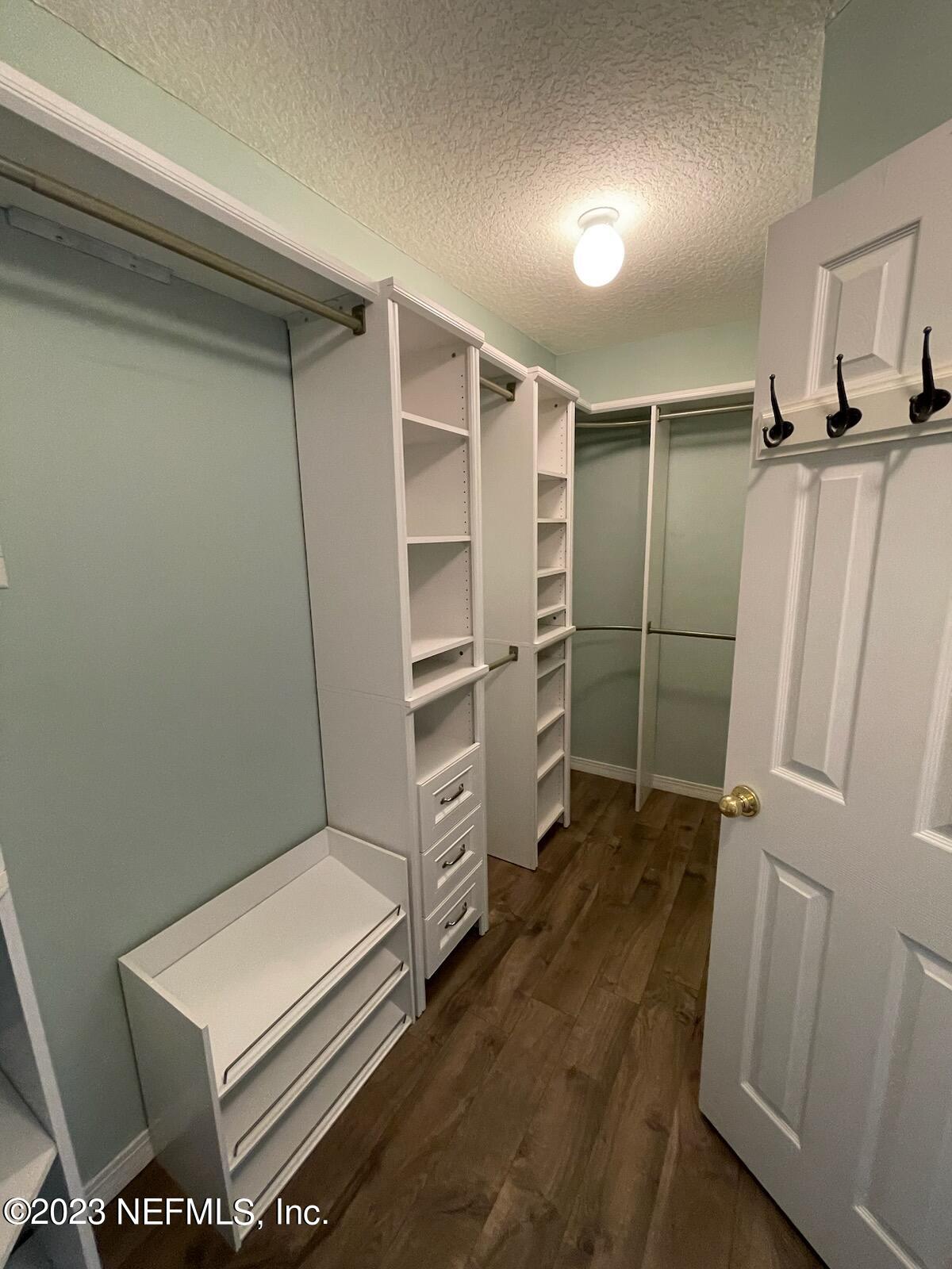 54025 Paddock Court Callahan, FL 32011 - Photo 21 of 47 a view of walk in closet with clothes and shoes