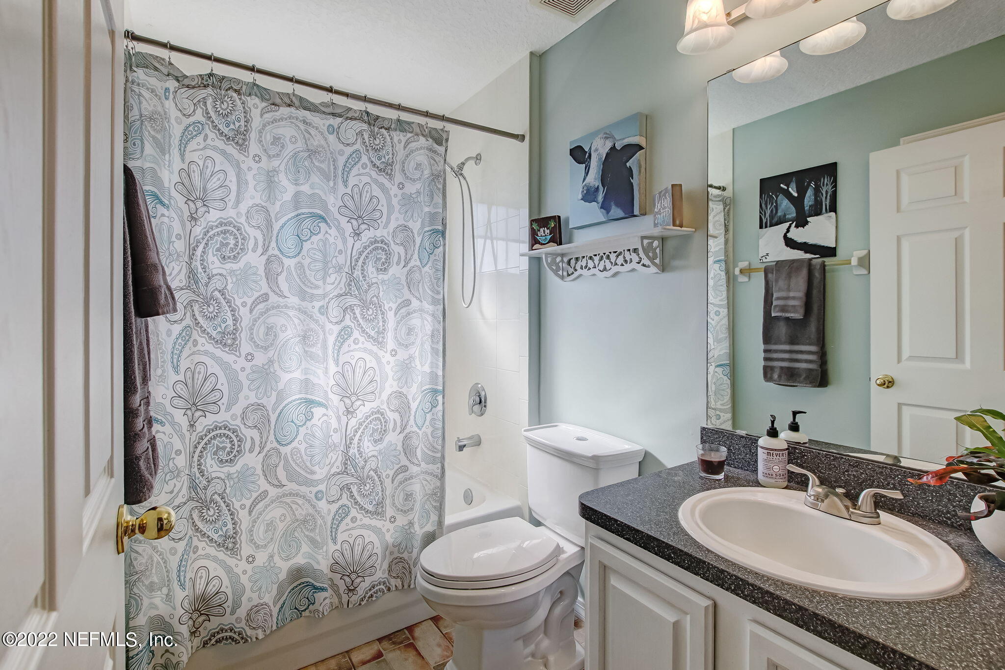54025 Paddock Court Callahan, FL 32011 - Photo 28 of 47 a bathroom with a granite countertop sink toilet and a mirror