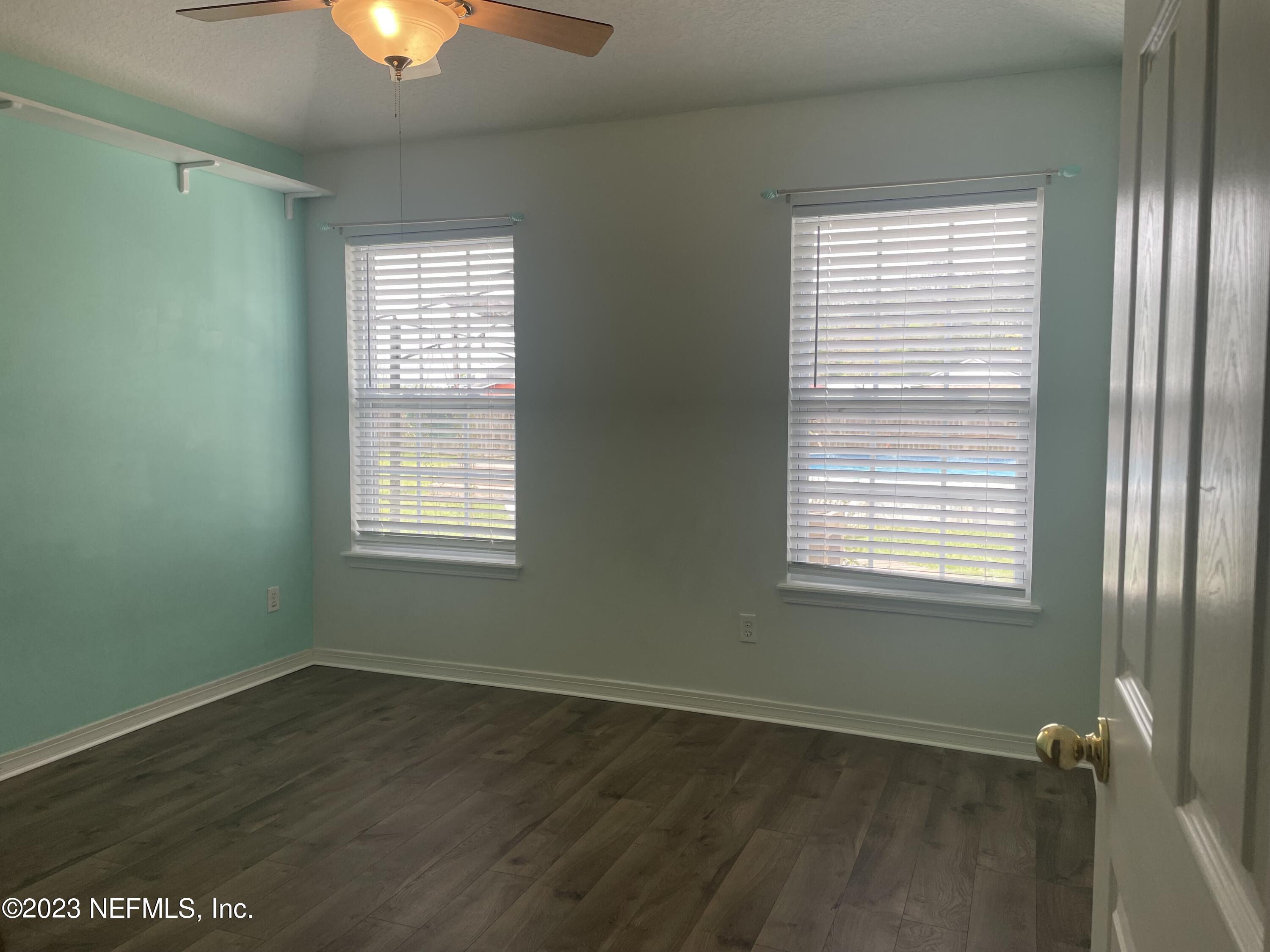 54025 Paddock Court Callahan, FL 32011 - Photo 30 of 47 a view of an empty room with a window and wooden floor