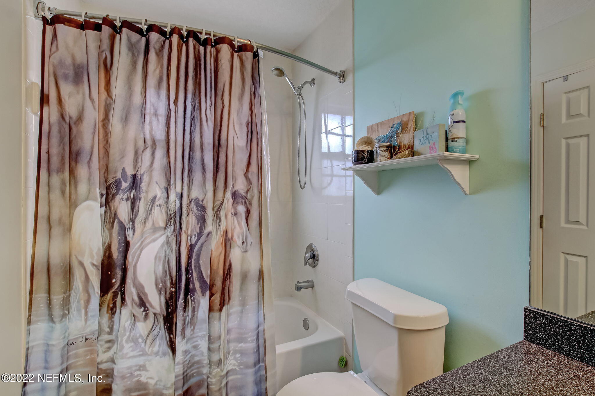 54025 Paddock Court Callahan, FL 32011 - Photo 32 of 47 a bathroom with a shower curtain and a toilet