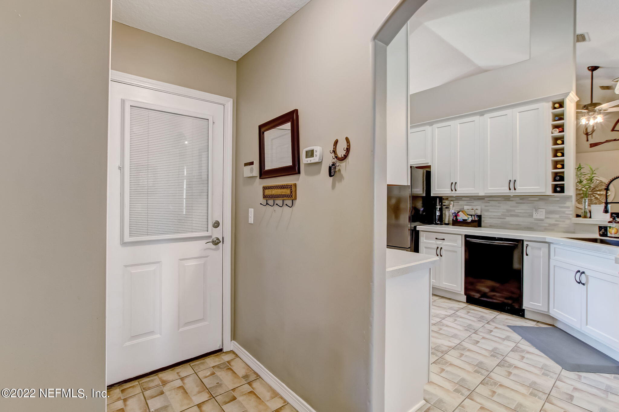 54025 Paddock Court Callahan, FL 32011 - Photo 33 of 47 a kitchen with stainless steel appliances a refrigerator sink and stove