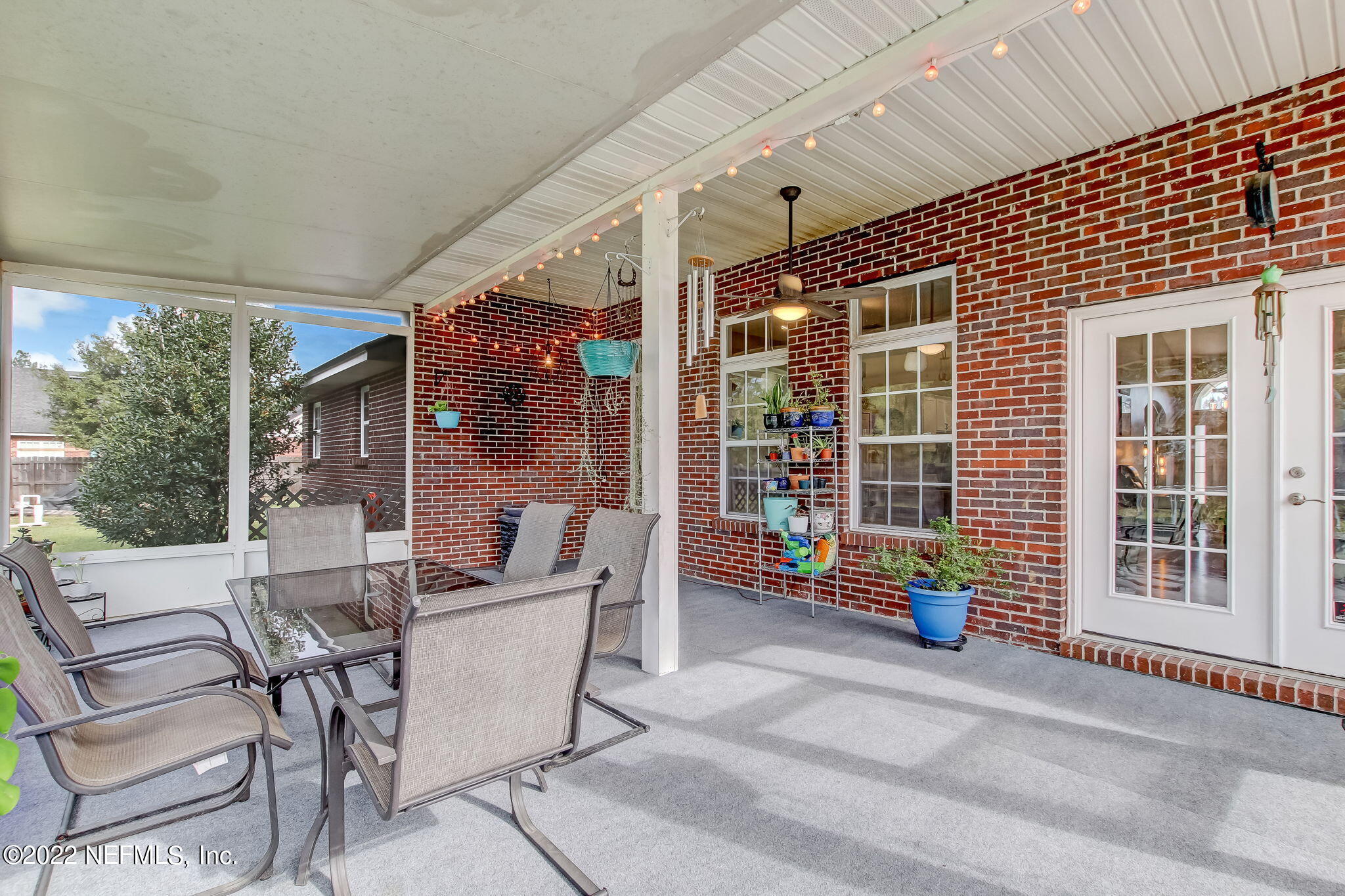 54025 Paddock Court Callahan, FL 32011 - Photo 36 of 47 a building outdoor space with patio furniture and potted plants