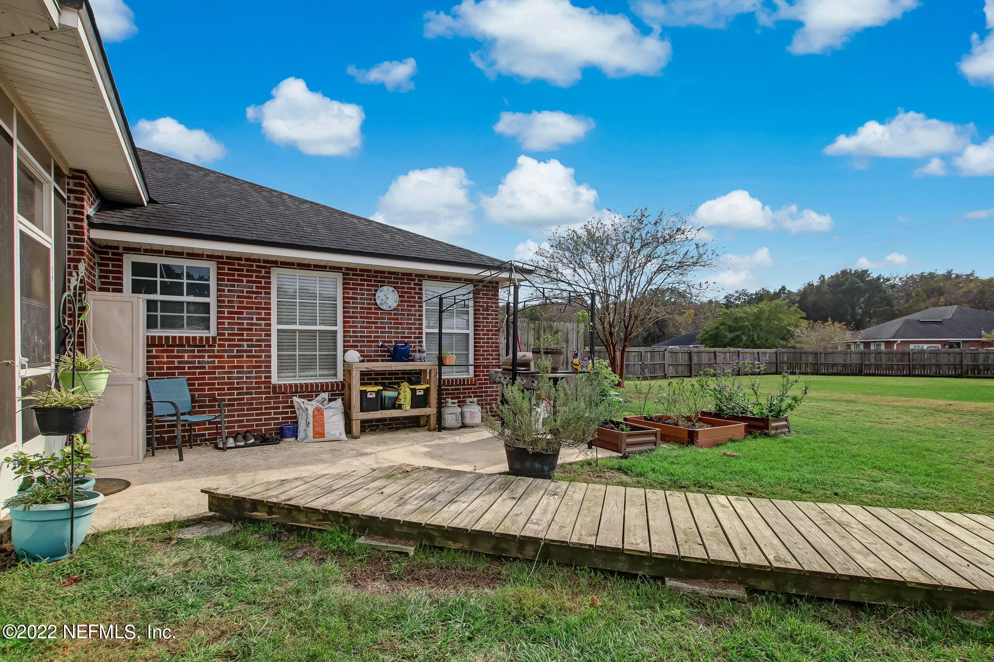 54025 Paddock Court Callahan, FL 32011 - Photo 40 of 47 a view of a house with backyard and sitting area
