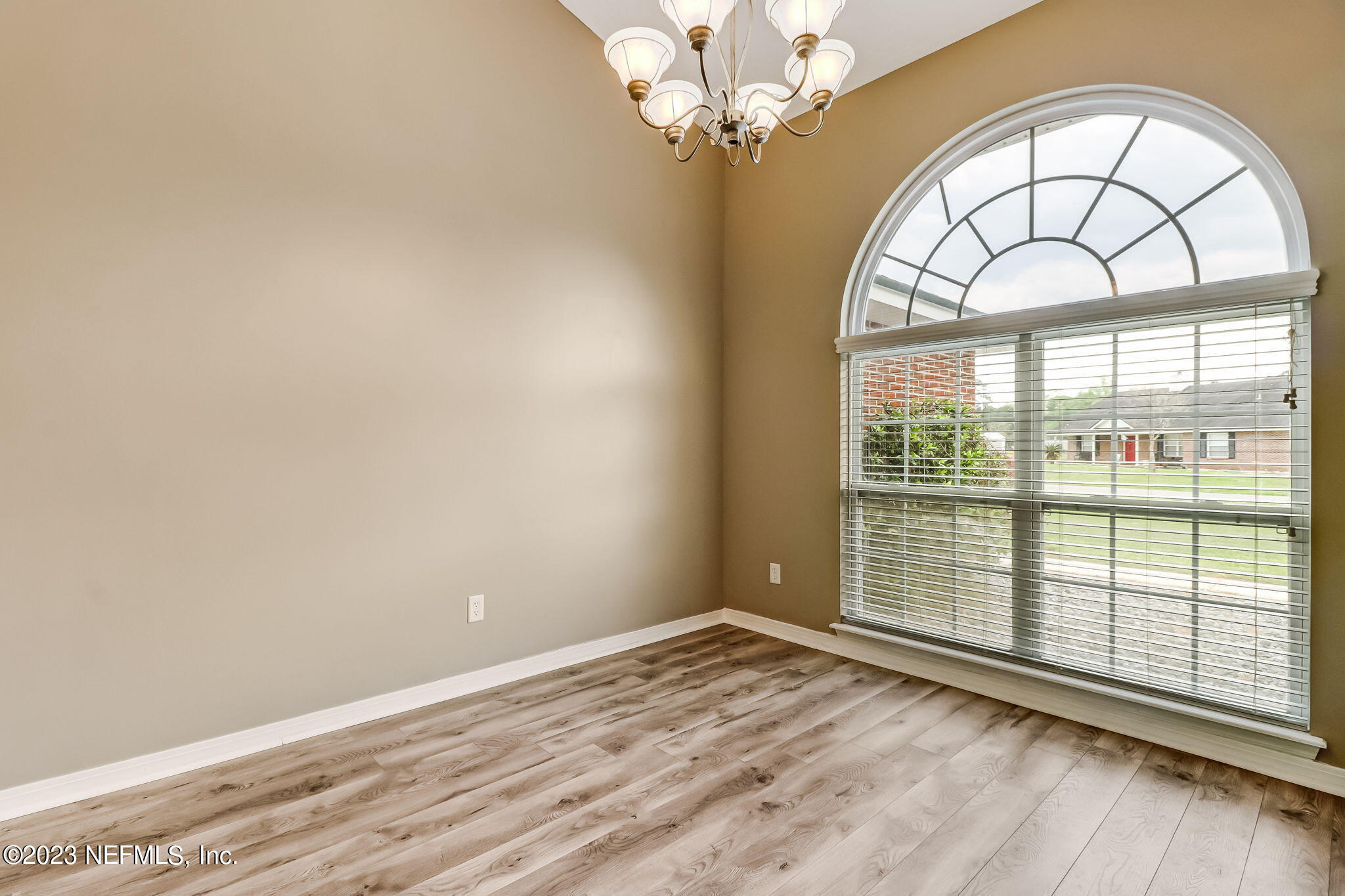 54025 Paddock Court Callahan, FL 32011 - Photo 7 of 47 an empty room with wooden floor and windows