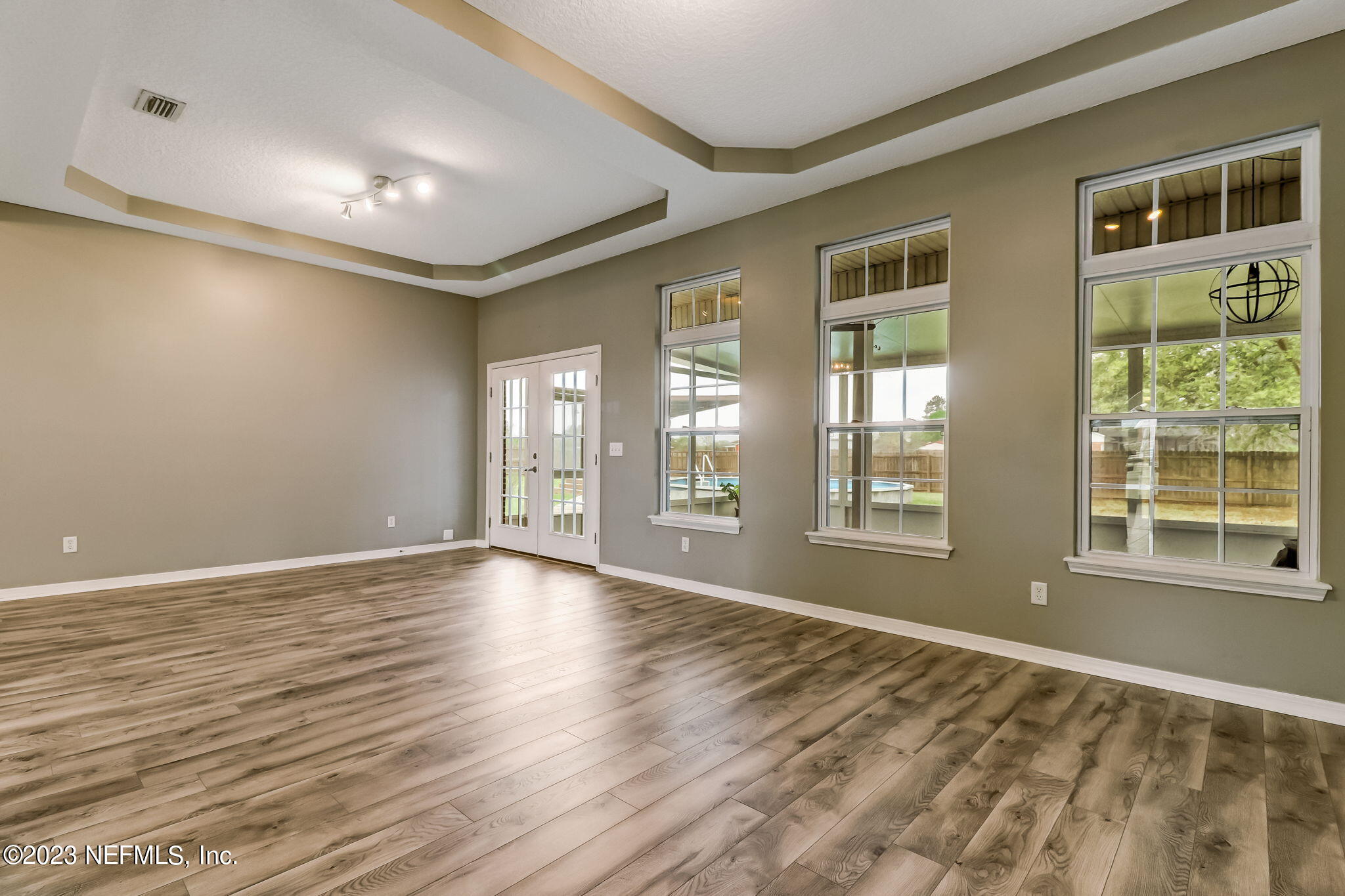 54025 Paddock Court Callahan, FL 32011 - Photo 9 of 47 a view of an empty room with wooden floor and a window