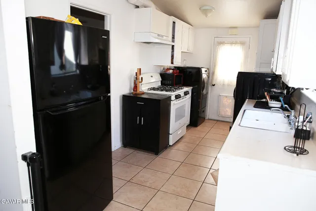 a kitchen with a refrigerator stove and sink