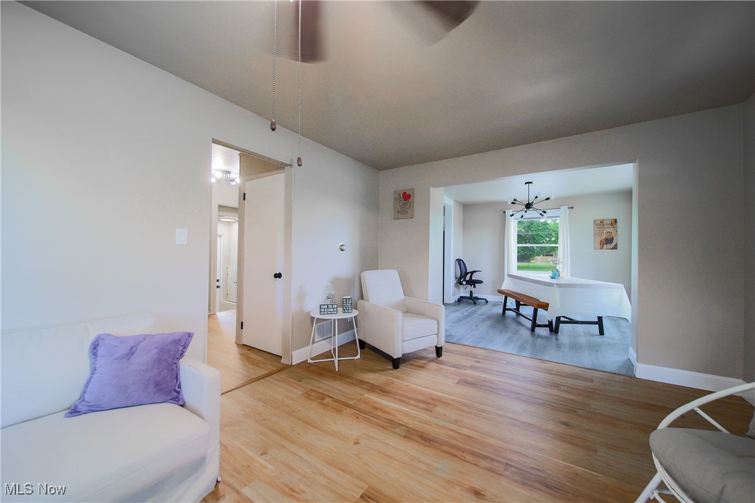 3181 Dover Road Wooster, OH 44691 - Photo 6 of 25 Living room with light hardwood / wood-style flooring and a notable chandelier