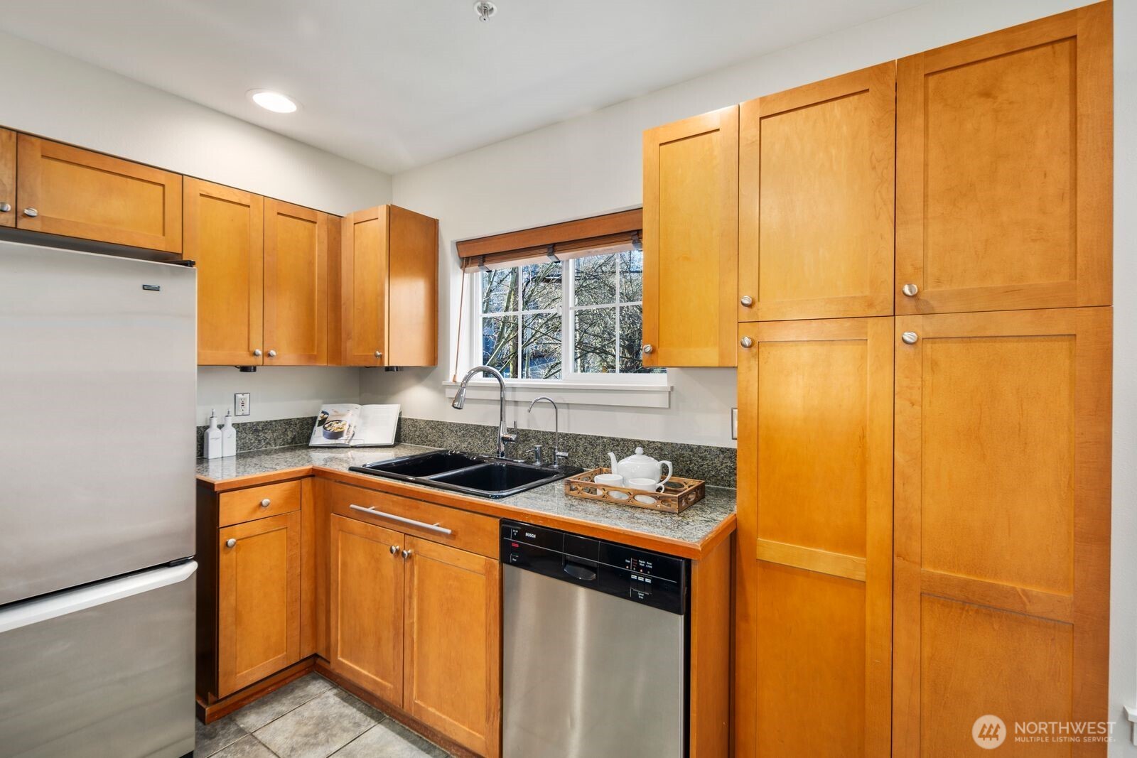 202 24th Avenue East, Unit 6 Seattle, WA 98112 - Photo 12 of 28 a kitchen with stainless steel appliances granite countertop cabinets sink and wooden floor