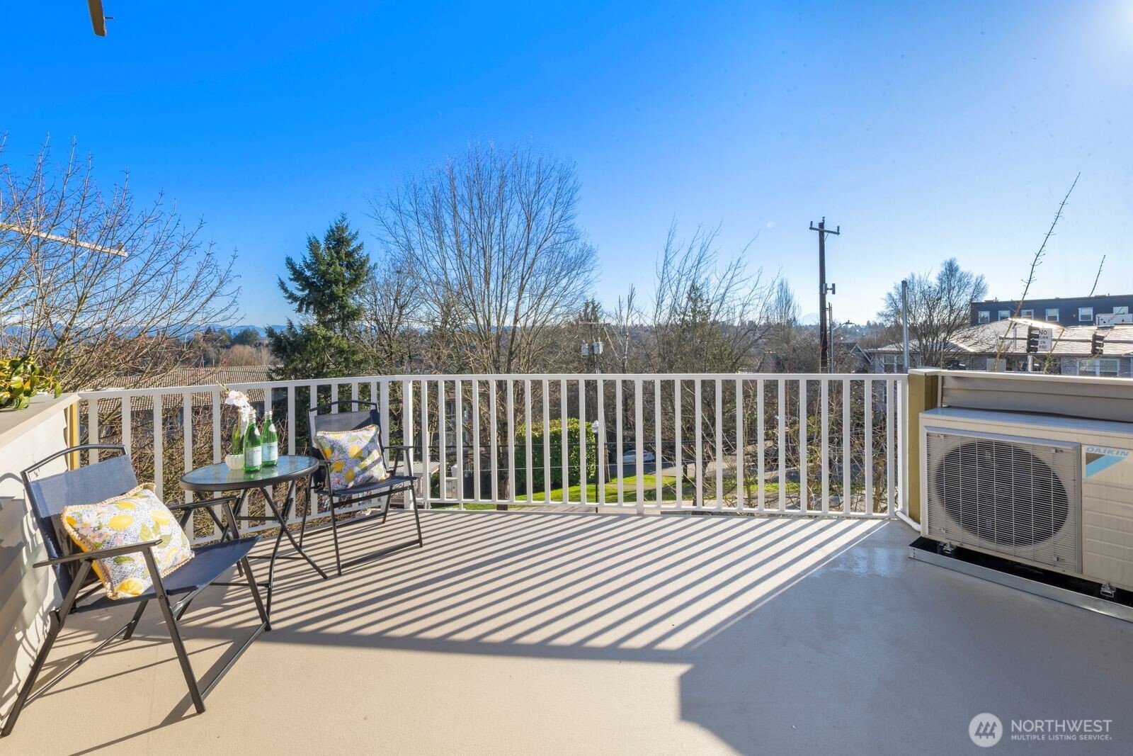 202 24th Avenue East, Unit 6 Seattle, WA 98112 - Photo 23 of 28 a balcony with wooden floor table and chairs