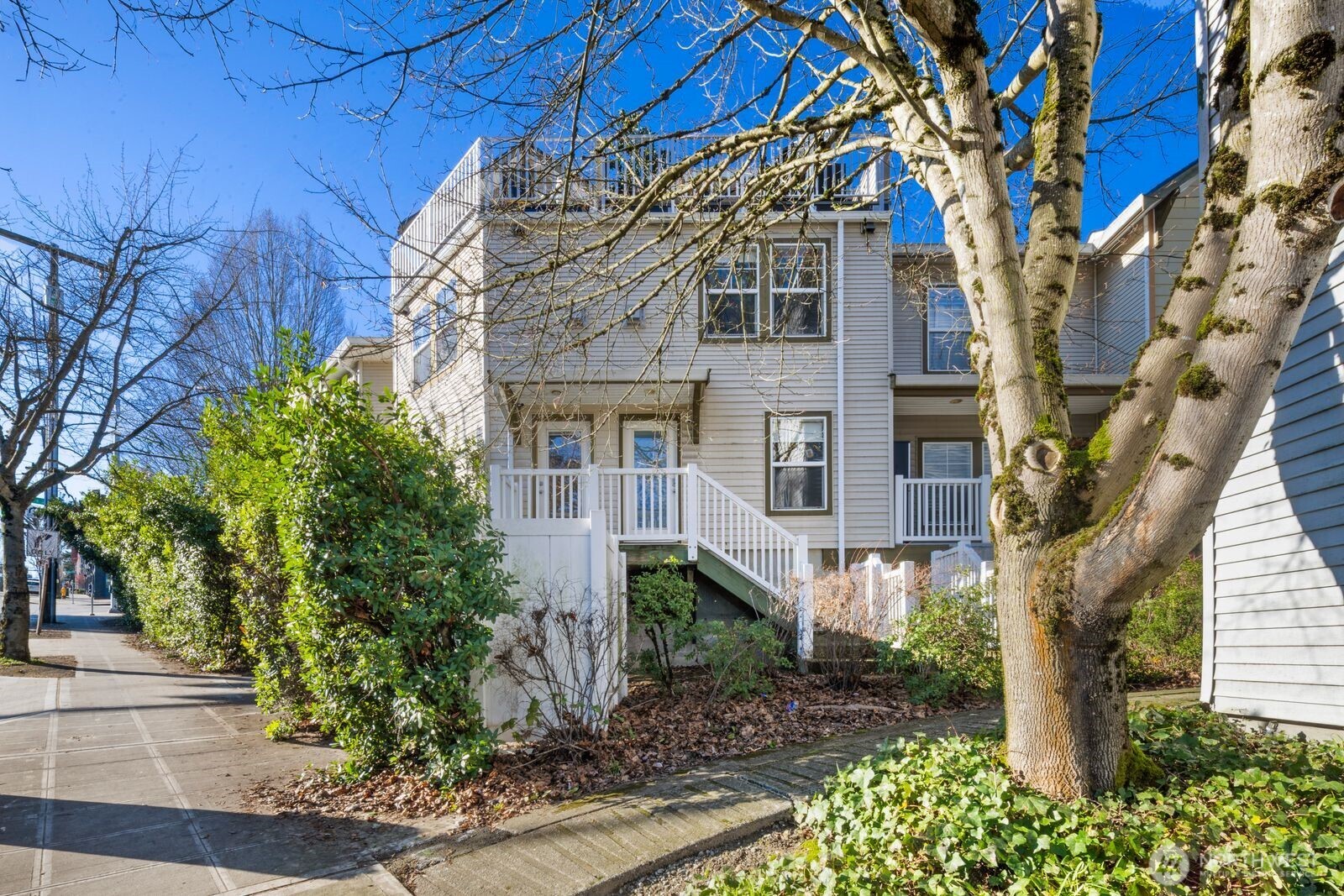 202 24th Avenue East, Unit 6 Seattle, WA 98112 - Photo 27 of 28 a front view of a house with a yard