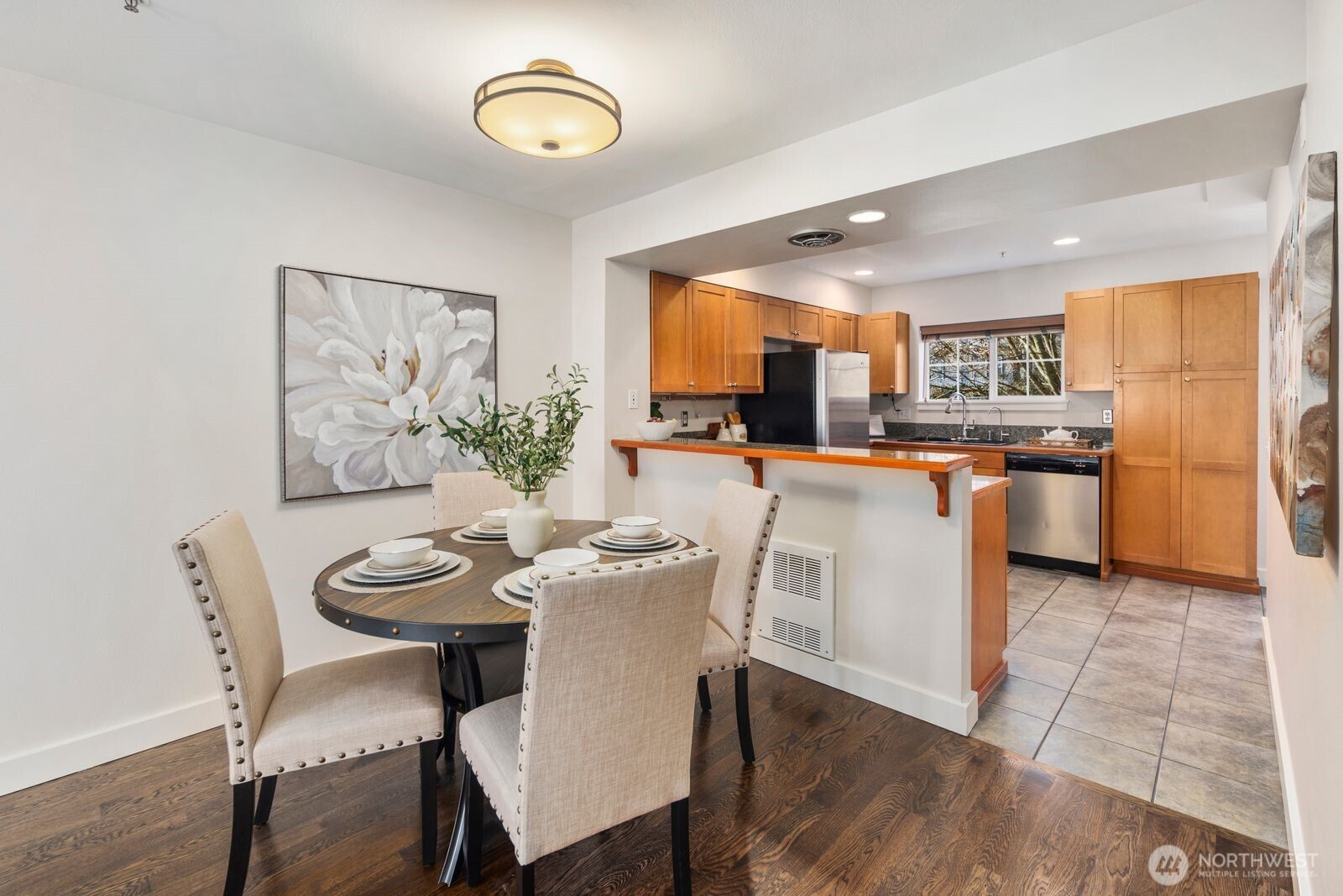 202 24th Avenue East, Unit 6 Seattle, WA 98112 - Photo 7 of 28 a dining room with stainless steel appliances a table and chairs