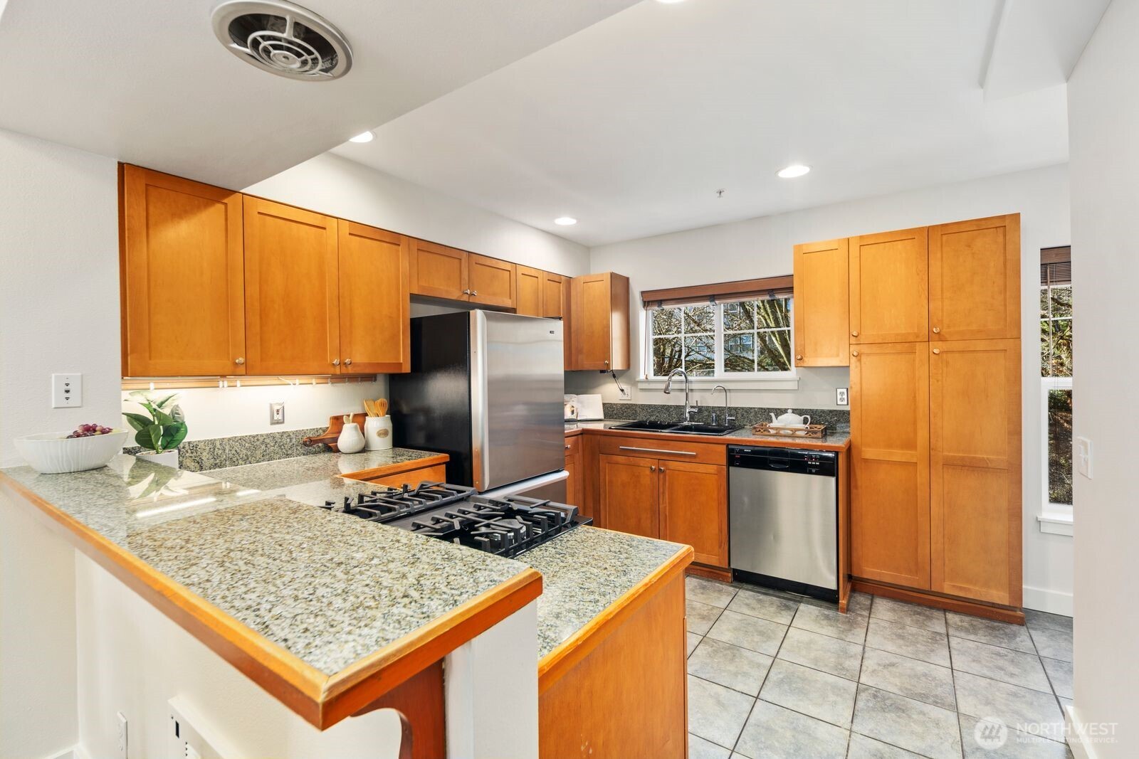 202 24th Avenue East, Unit 6 Seattle, WA 98112 - Photo 8 of 28 a kitchen with stainless steel appliances granite countertop a sink stove and refrigerator