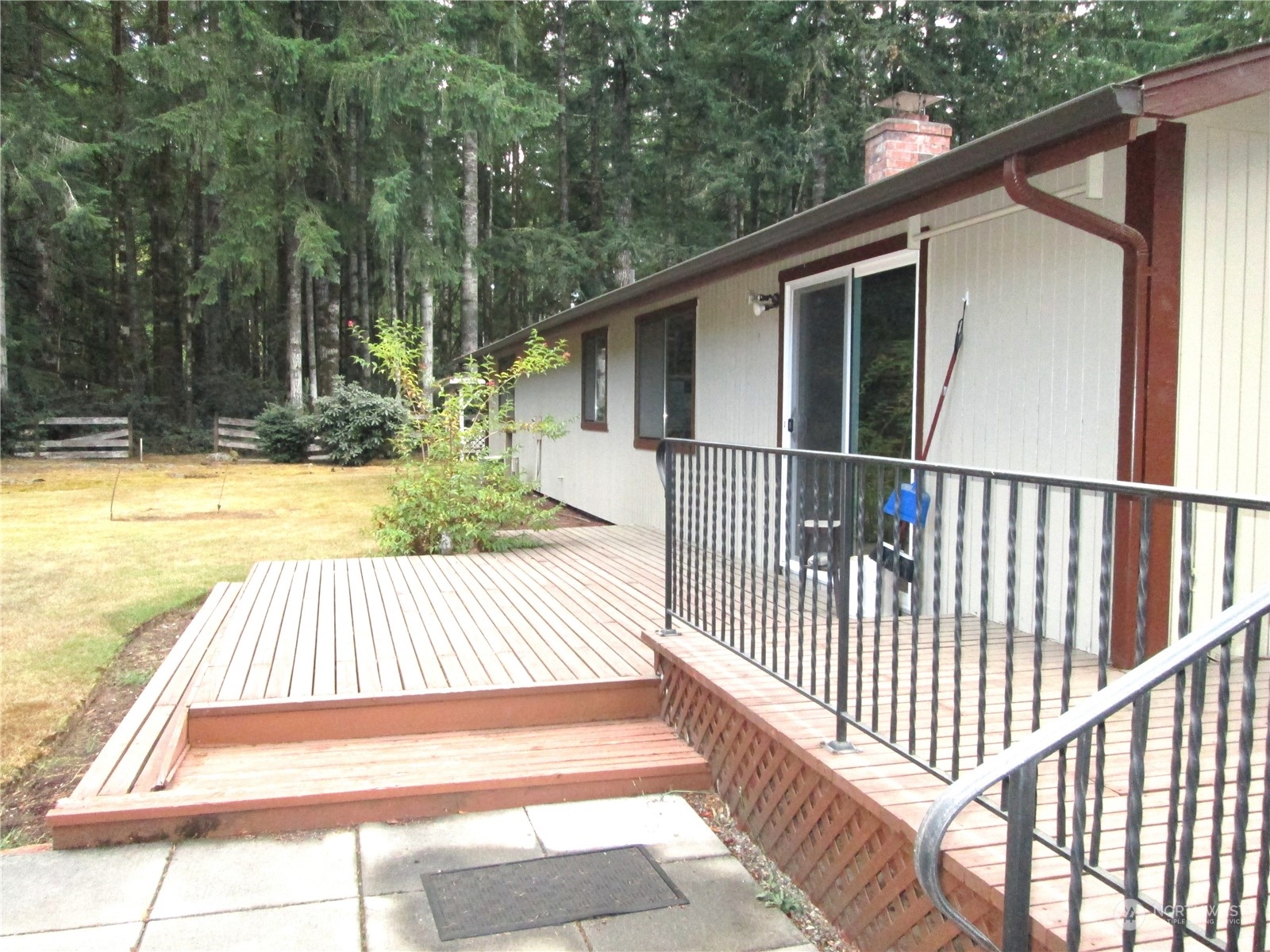 15 Webb Road Southwest Lakebay, WA 98349 - Photo 14 of 39 a view of backyard with large trees and wooden fence