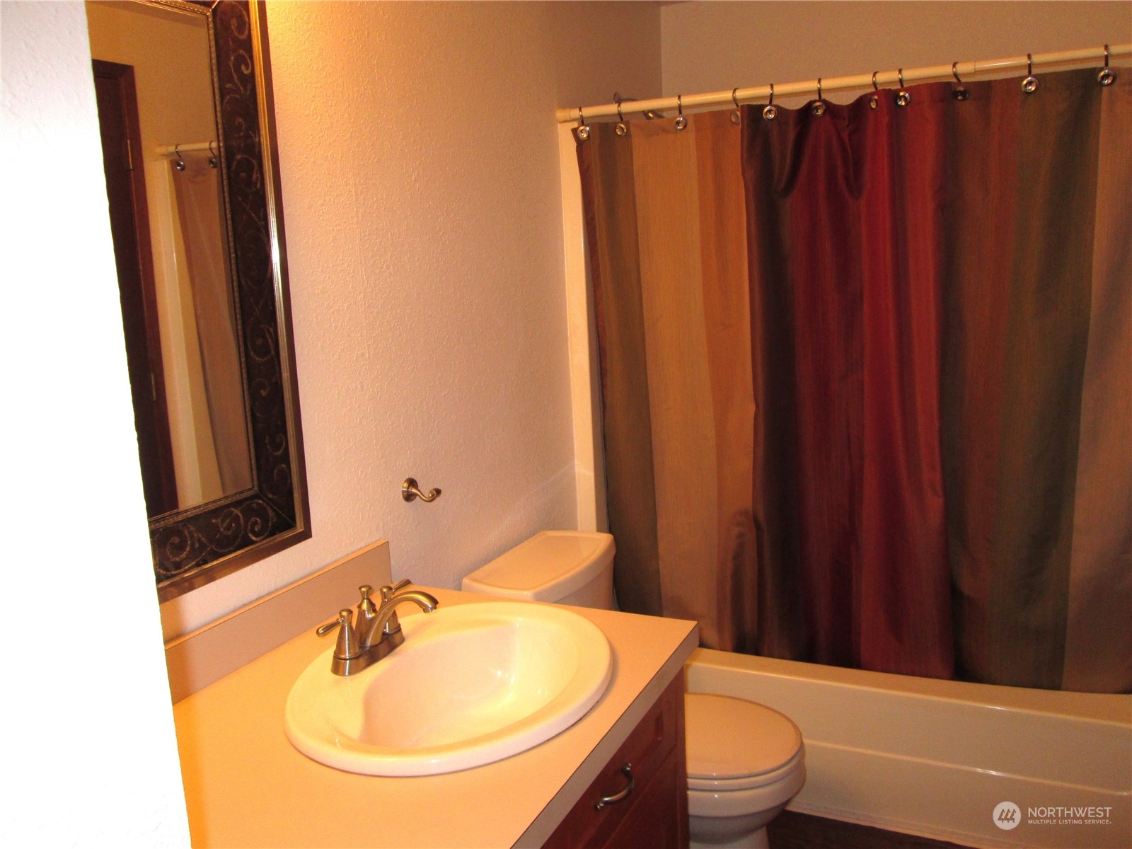 15 Webb Road Southwest Lakebay, WA 98349 - Photo 19 of 39 a bathroom with a sink a toilet a mirror and shower curtain